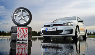 Volkswagen Golf Mk7 parked next to a stack of tyres